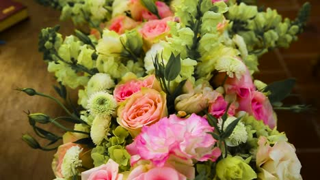 flowers arrangement with pink and purple roses in the table for a wedding