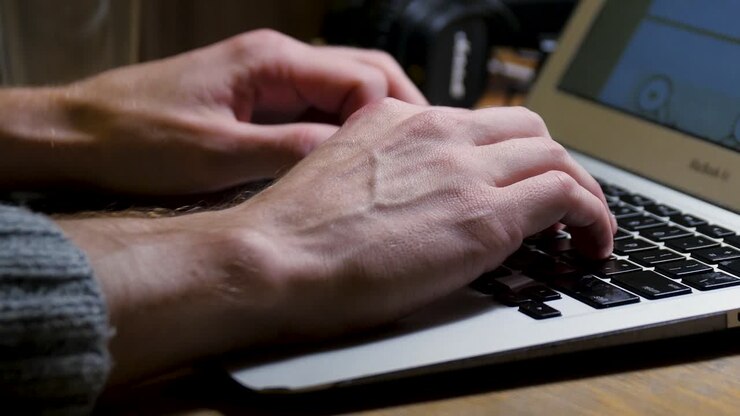 Person Typing on a Laptop