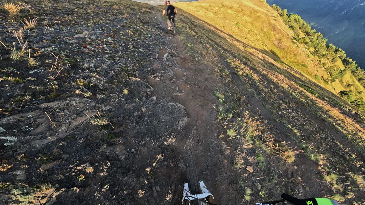 POV Mountain Biking Down a Scenic Mountain Ridge Trail