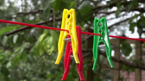 plastic clothes pegs on washing line. uk