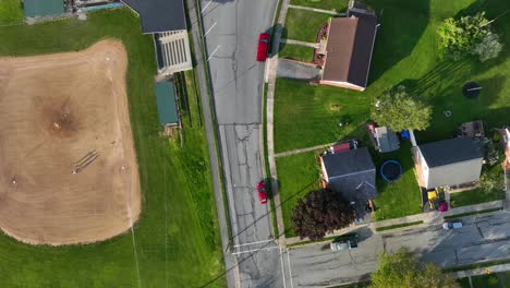 A-top-down-shot-of-an-american-town-baseball-field-next-to-a-street-road-in-the-suburbs-and-town-of-USA