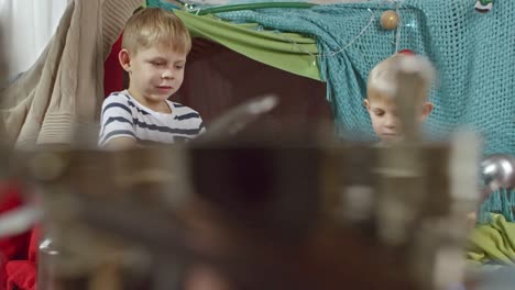 little brothers playing music on metal pots