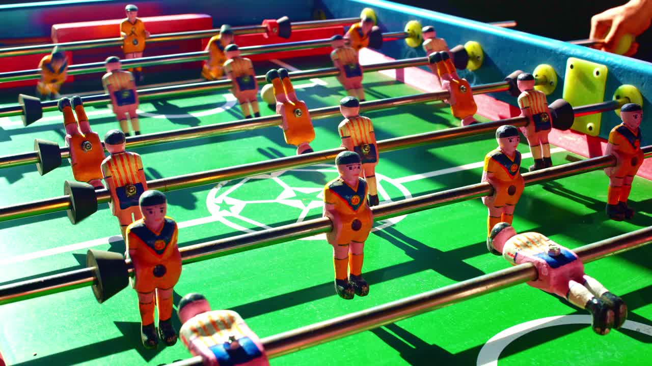 Close-up of a miniature soccer field, a typical game in Mexico with the sunset light