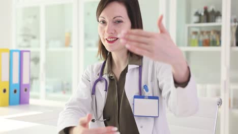 female doctor gesturing and talking in medical office