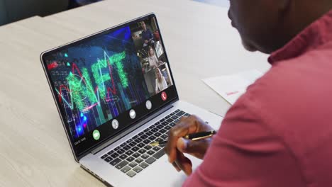 video of african american man having nft video call on laptop with diverse coworkers