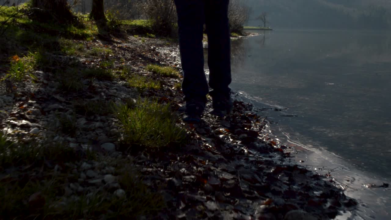 Walking by a mountain lake, with a low angle follow cam