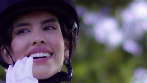 Charming-Smiling-Brazilian-Horse-Rider-Woman-Face-Closeup-While-Adjusting-Helmet-Straps-Tightness---slow-motion