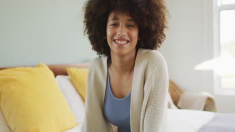 portrait of happy biracial woman smiling and looking at camera