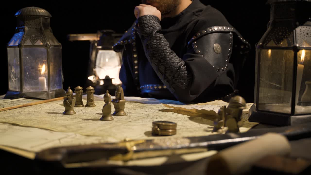 Making war plans in ancient times. By candlelight. Historical scenes.