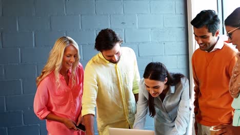 Business-colleagues-using-laptop-in-meeting