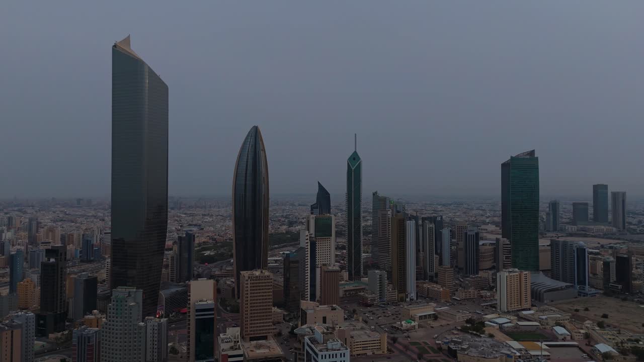 Dramatic 4K aerial shot of Kuwait’s skyline on a cloudy day. Modern towers and dense urban landscape—ideal for documentaries, real estate, and cinematic city visuals.
