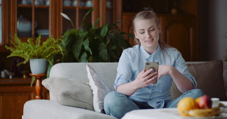 woman talking on mobile at home 2