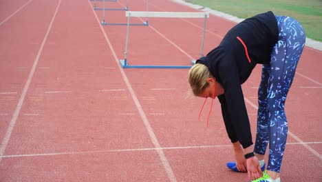Female-athlete-exercising-on-a-running-track-4k