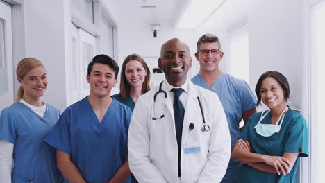 Portrait-Of-Smiling-Multi-Cultural-Medical-Team-Standing-In-Hospital-Corridor