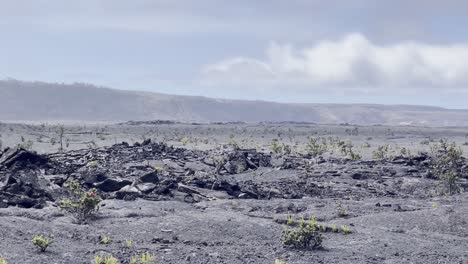 Cinematic-long-lens-panning-shot-of-the-desolate-wasteland-along-the-edge-of-Kilauea-Crater-in-Hawai'i-Volcanoes-National-Park