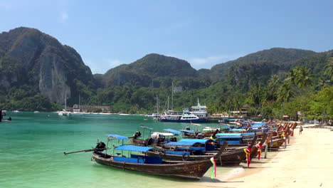 longtail boats on a tropical beach in thailand