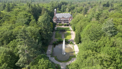 jib up of beautiful mansion with a spewing water fountain in the foreground