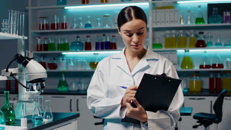 scientist taking notes in a modern laboratory
