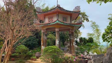 colorful pagoda in lush garden with blooming flowers and trees