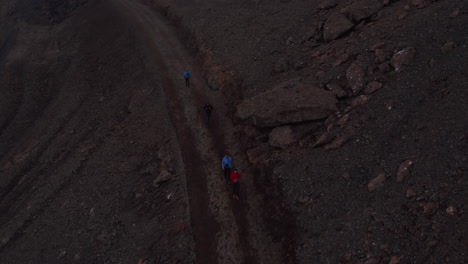 Overhead-view-four-backpacker-traveler-walking-pathway-trekking-in-Iceland.-Top-down-view-adventurous-people-hikers-exploring-isolated-icelandic-land