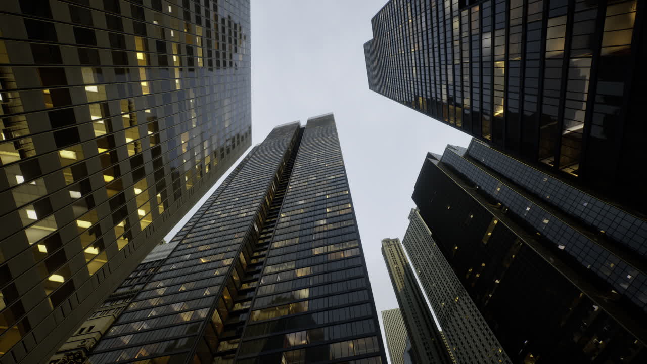 City skyscrapers tower above with glowing windows in evening light