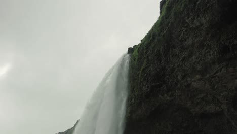 Tilt-up-from-in-front-of-a-waterfall-in-Iceland