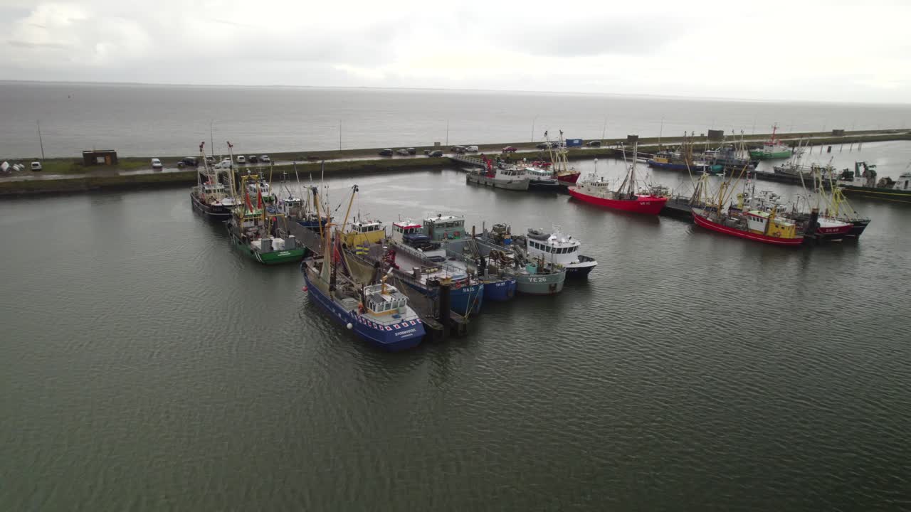 Gritty Dutch Harbor: Aerial Shot of Fishing Ships Resting Under a Moody Sky