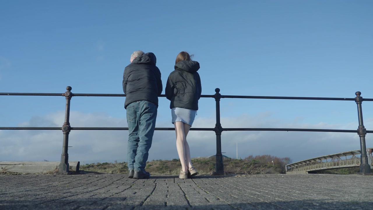Dad and daughter, side by side, gazing ahead with hearts open wide