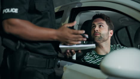 police officer issuing a ticket to a driver during a traffic stop