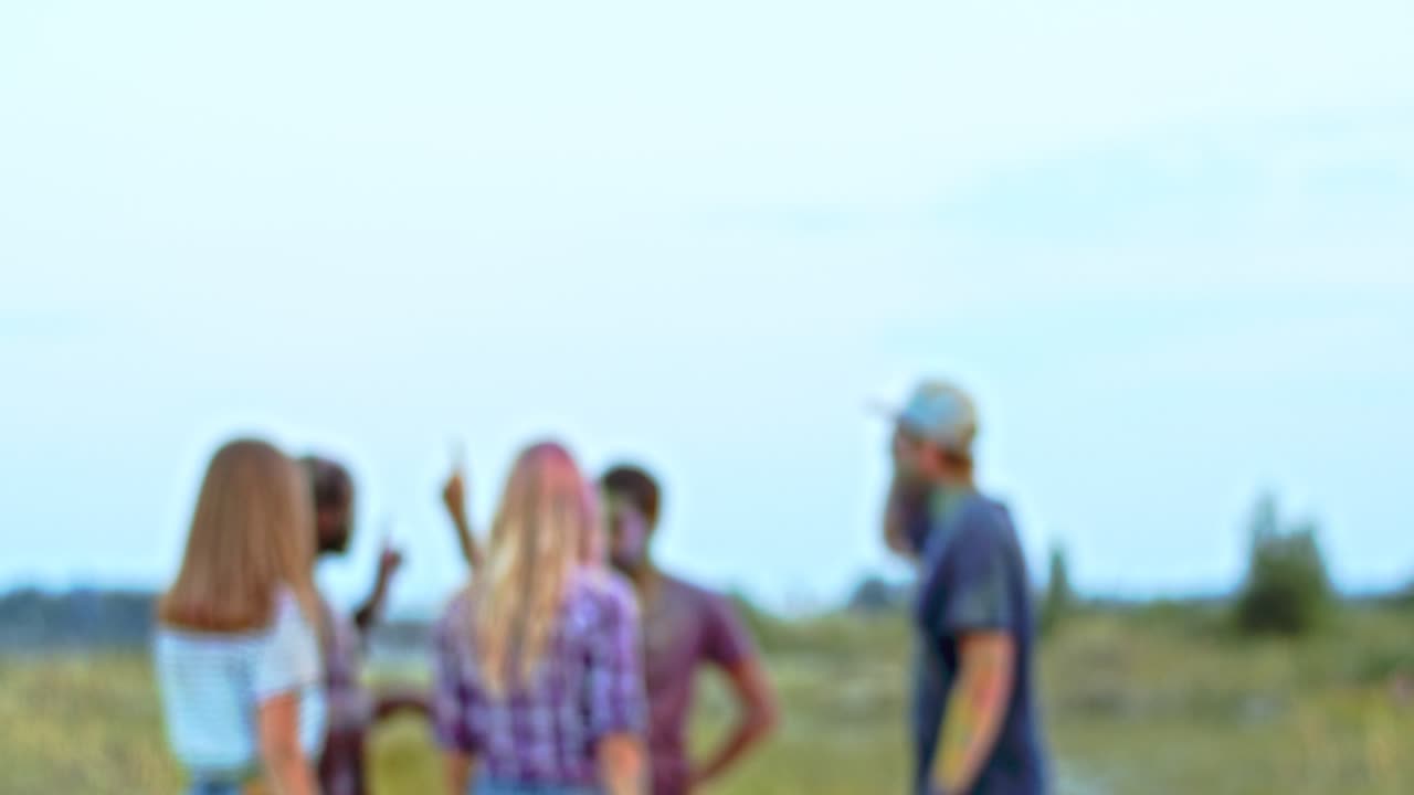 Blurred Shot Of The Young People Dancing And Having Fun Outdoors At The Holi Festival, Blond Girl Coming Closer To Camera, Smiling And Posing To The Camera