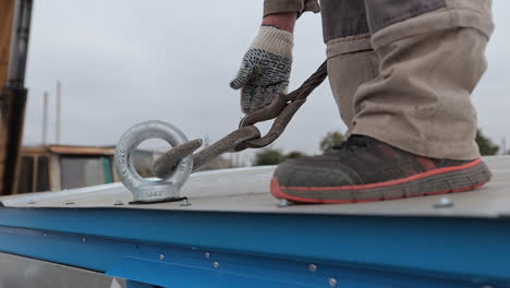 worker securing a load on a rooftop