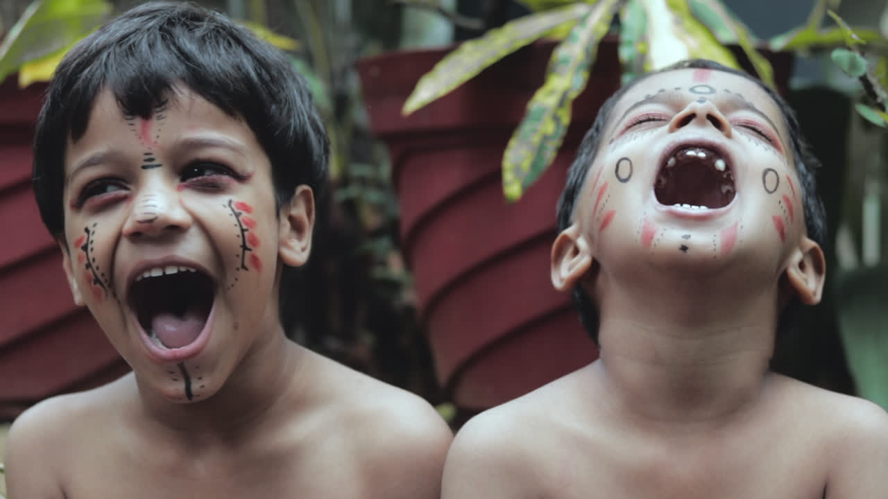 TRIBAL BOYS WITH THEIR TRADITIONAL MAKEUPS LAUGHING PORTRAIT IN SLOW-MOTION.