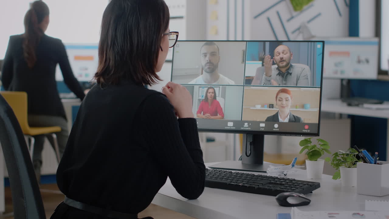 Corporate worker talking to colleagues on video call