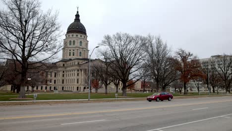 edificio del capitolio del estado de kansas en topeka, kansas con vehículos que pasan y video estable