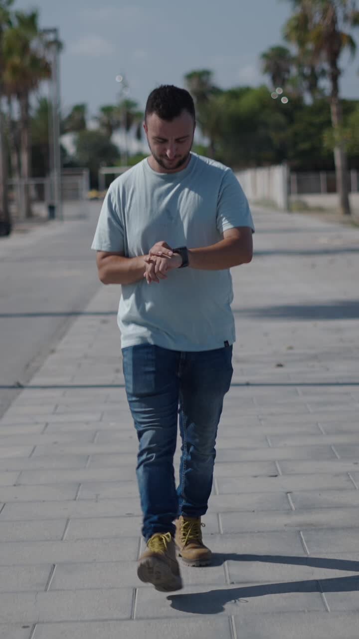 Man walking down the street checking his watch
