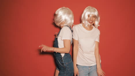 two happy girls dancing in studio