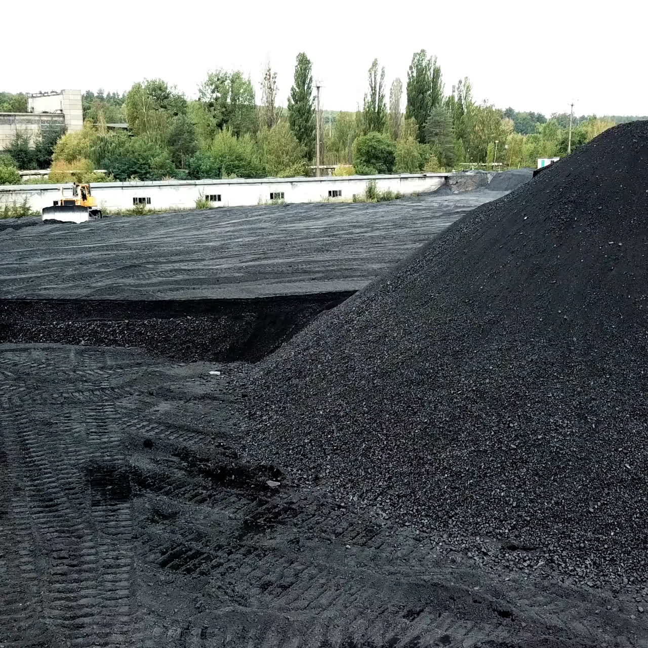 Aerial view of big pile of coal. Extractive industry, anthracite. Coal mining at an open pit