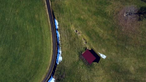 Following-the-path-trough-a-green-landscape-seen-from-the-top-down