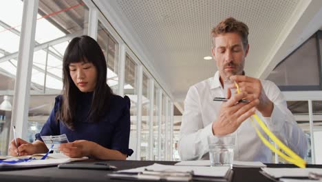 Two-colleagues-preparing-name-tags-at-a-business-conference