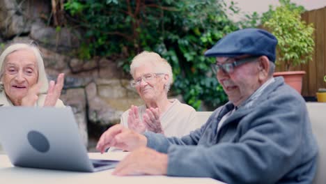 elderly people enjoying a video call on a laptop
