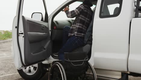 disabled man with wheelchair getting into his car