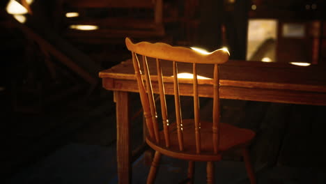 sunlit wooden chair beside a rustic table in a cozy cabin during the afternoon