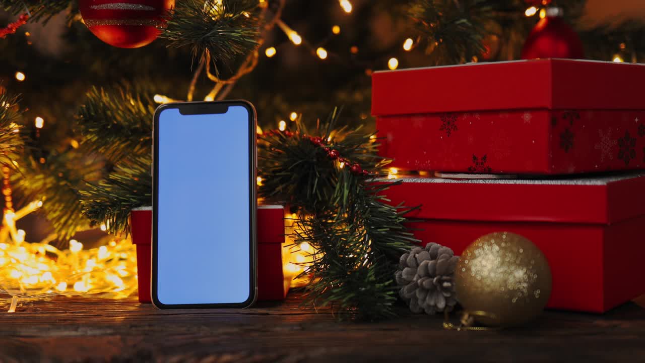 fondo de navidad caja de regalo roja teléfono inteligente gadget pantalla azul luces parpadeantes