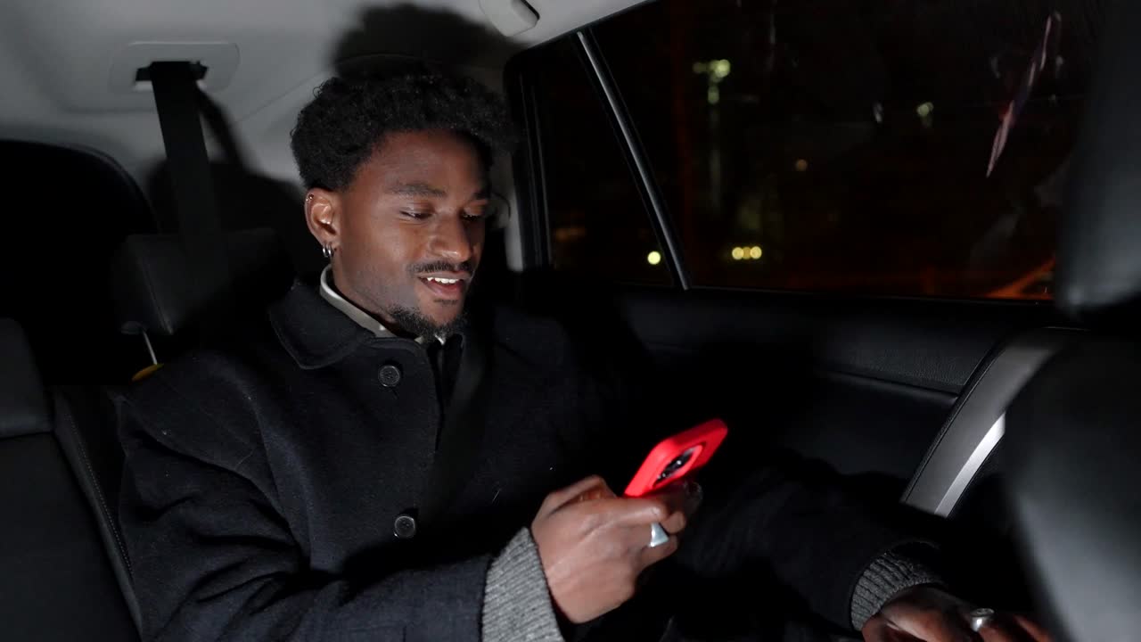 Man in car at night with phone