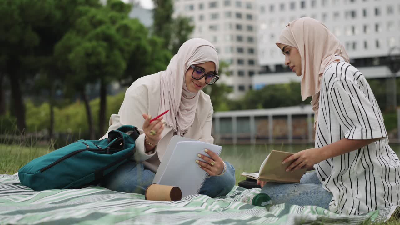 Two Muslim Women Studying Together in a Park