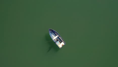 woman on the boat catches a fish on spinning in norway.