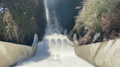 top view of water flowing down a hydroelectric power generator dam, capilano dam, north vancouver