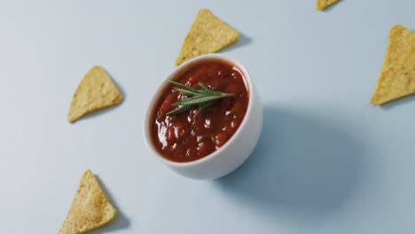 Video-of-tortilla-chips-and-salsa-dip-on-a-grey-surface