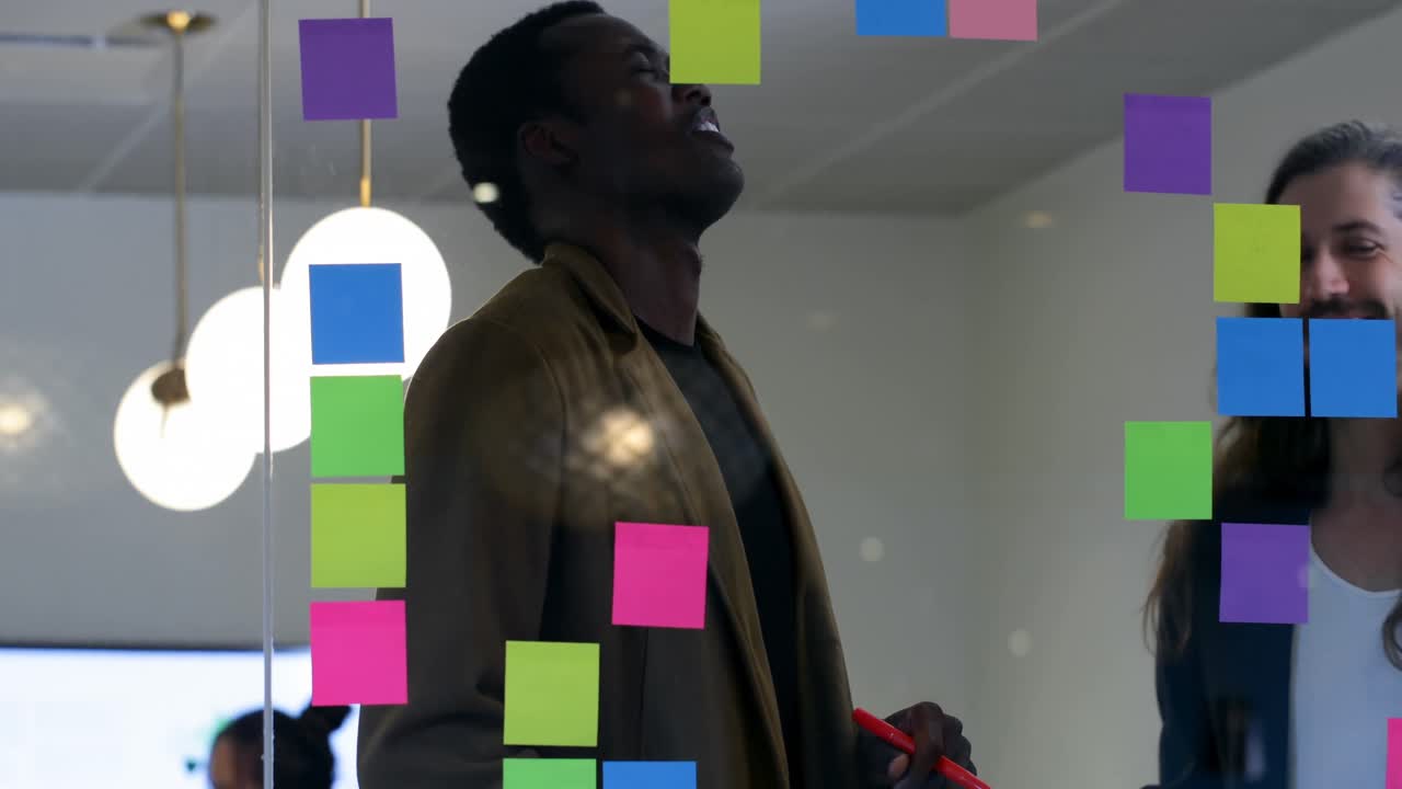 Business colleagues discussing over sticky notes in office 4k
