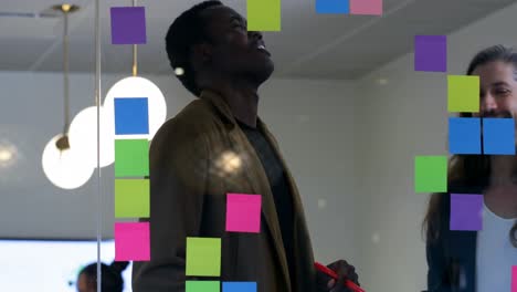 business colleagues discussing over sticky notes in office 4k